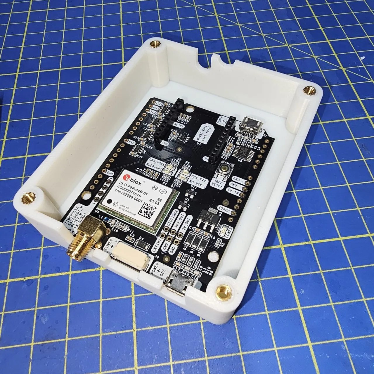 The main board is locked in the bottom cover exposing the antenna connector and the communication ports